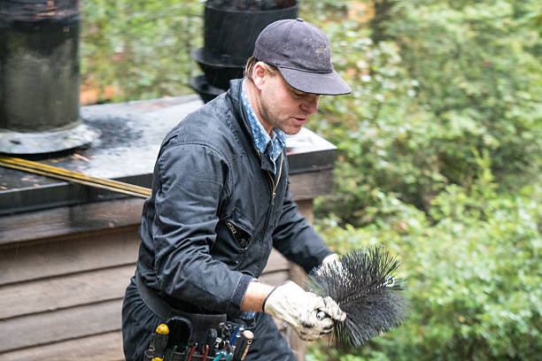 Chimney Sweep cleaning on roof of house cleaning dirty chimney