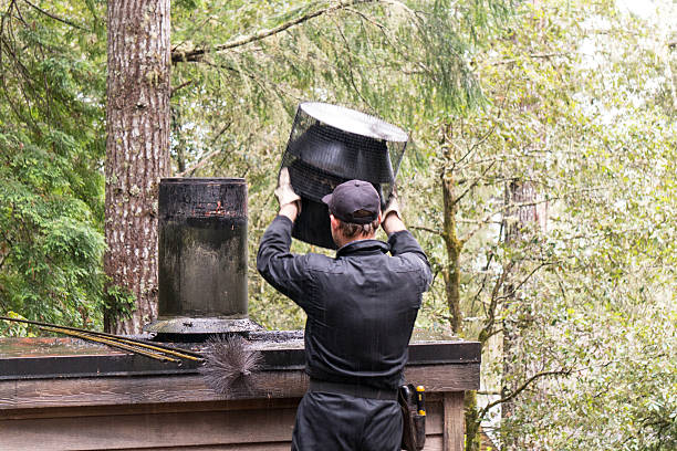 Chimney Sweep cleaning on roof of house cleaning dirty chimney